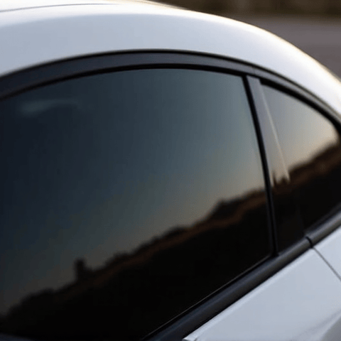 Close-up of XPEL Prime XR Plus ceramic window tint being meticulously installed on a car window by a skilled technician in Santa Clarita. This image captures the precision and expertise involved in applying premium heat rejection tint, ensuring flawless results and optimal performance against intense California sun.